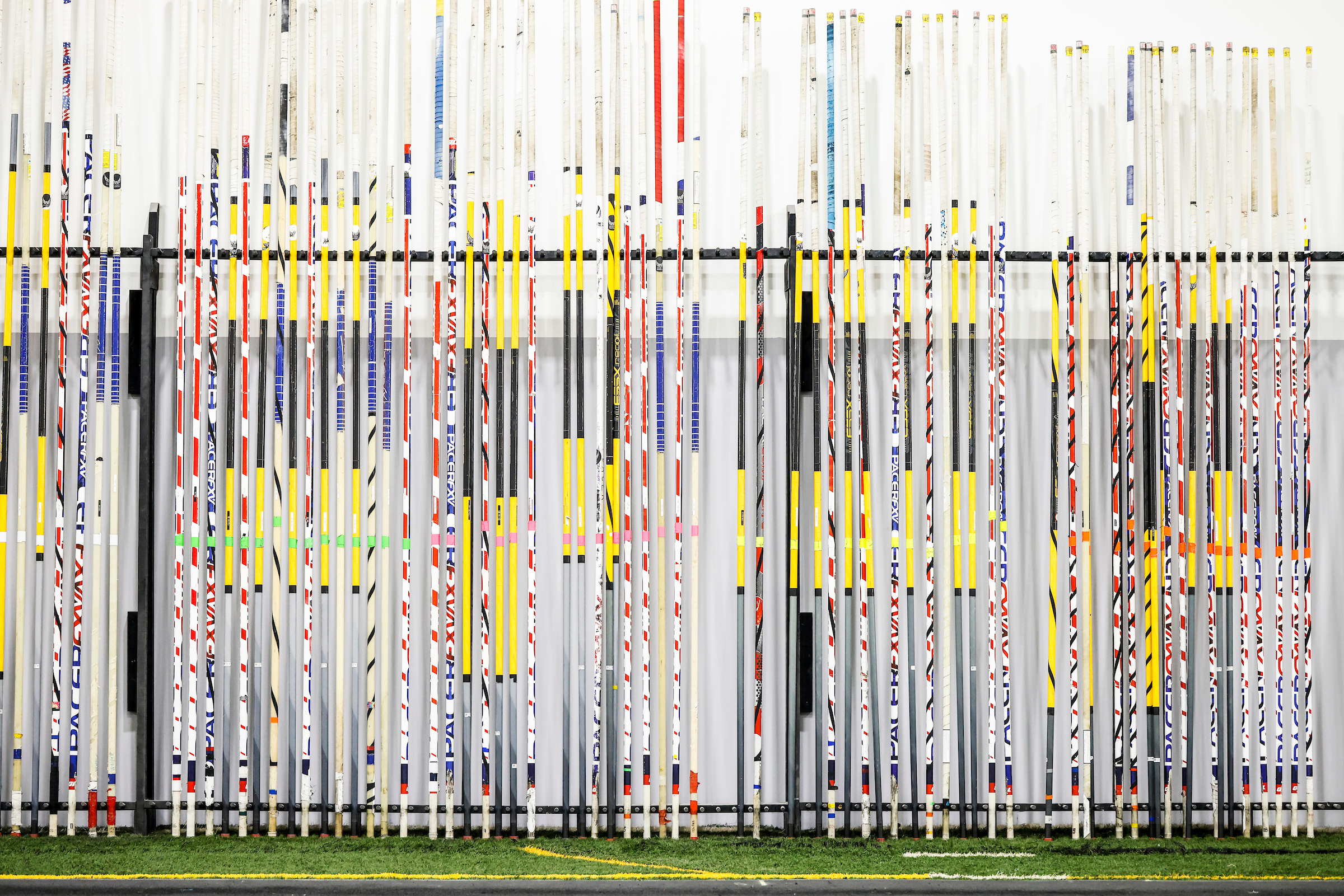 Wall of pole vault poles on the rack at RISE